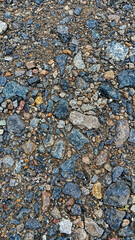 A detailed view of small rocks and gravel scattered across a dirt surface, showcasing natural textures.