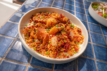 Deep-fried streaky pork with chili and salt in plate on blue tiled surface, Thai dish