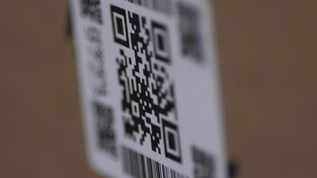 close-up of a QR code scanned with a laser beam barcode scanner, a QR code on a parcel or item scanned with a laser