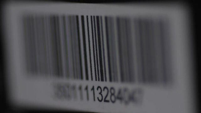 close-up of a barcode being scanned with a laser beam barcode scanner, a barcode on a parcel or product being scanned with a laser