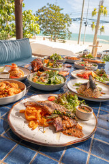 Grilled pork chop with curry fried onion and pepper sauce on blue tiled suface