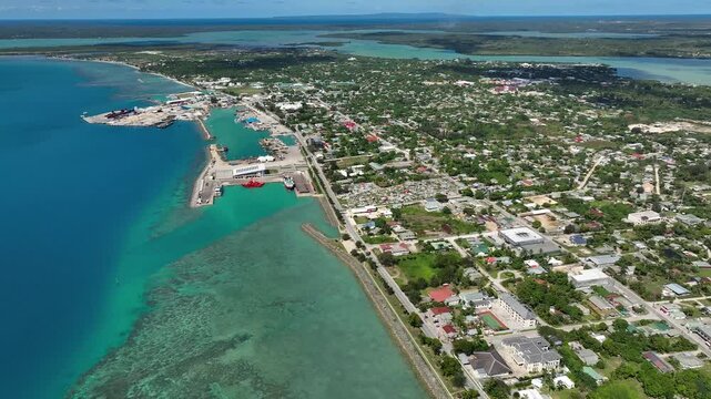 Drone flight over Nuku'alofa, the capital of the Kingdom of Tonga. The building of the royal residence and the sights of the town of Nuku'alofa. Panorama of Tongatapu Island. Cityscape from a bird's e