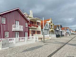 Colorful facades of houses along the streets of Costa Nova, Aveiro, showcasing the vibrant and...
