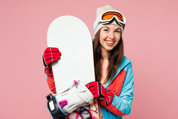 Snowboarder young surprised happy woman wear warm blue padded jacket ski goggles mask spend extreme...