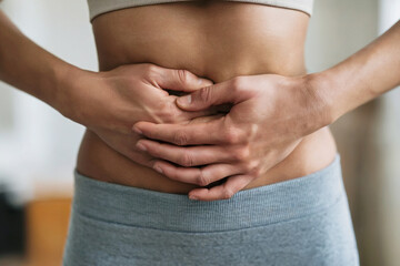 Fototapeta premium Woman suffering from abdominal pain at home