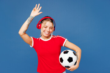 Young happy woman fan wear basic red t-shirt cheer up support football sport team hold in hand...