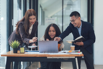 Collaborative Brainstorming: A diverse team of professionals huddle around a laptop, engaged in a lively brainstorming session.