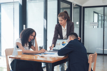Business Strategy Meeting: A diverse team of professionals engage in a collaborative meeting,...