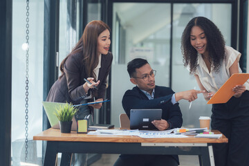 Business Collaboration: A diverse team of professionals collaborate, sharing ideas and discussing strategies in a modern office setting, fostering a dynamic and engaging work environment. 