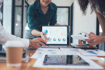 Collaborative Data Analysis:  A diverse team of professionals collaborates around a laptop,...
