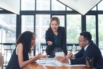 Business Collaboration: A diverse team of professionals collaborates in a modern office setting, showcasing a dynamic and engaging work environment.