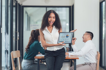 Fototapeta premium Businesswoman Presenting Data: Excitement and Success in a Modern Office Setting 