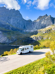 Scenic drive through norway's majestic mountains in a white camper van offers a breathtaking view of travel and adventure © Alberto Gonzalez 