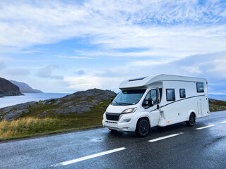 Scenic drive along the norwegian coast in a white camper van on a rainy autumn day