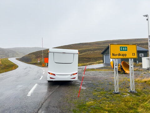 Camper van traveling on the e69 road to nordkapp, norway, on a rainy and foggy day