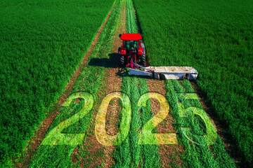 2025 Happy New Year concept and red tractor mowing green field.
