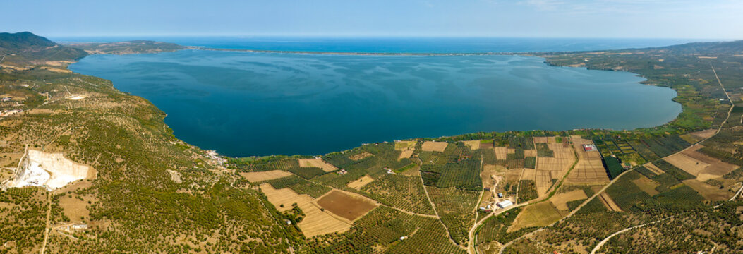 Panoramic aerial view of Varano Lake. It is a coastal lake located in the province of Foggia, in Gargano, Puglia, Italy. In the background is the Adriatic Sea.