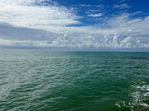 Ocean waters and sky clouds horizon