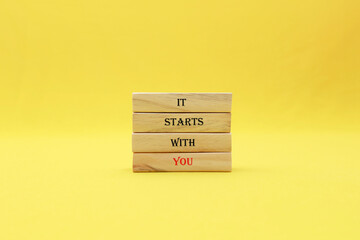 It starts with you symbol. Wooden blocks with words It starts with you. Beautiful yellow...