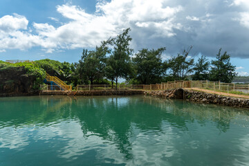 Obraz premium Snorkeling adventures await in the tranquil waters of Inalåhan, Guam, surrounded by lush nature