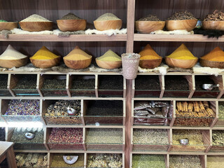 Different colorful spices on the shelves.