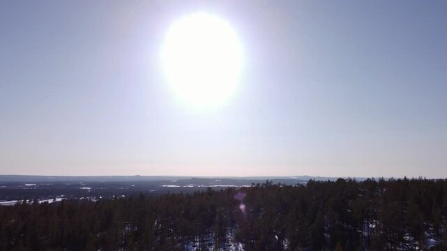 Aerial shot, slowly ascending above the mountain and revealing the northern swedish landscape