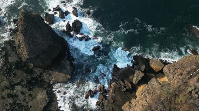 Aerial view of Papuma Beach Jember East Java with rocky beach and fishing boat on waves