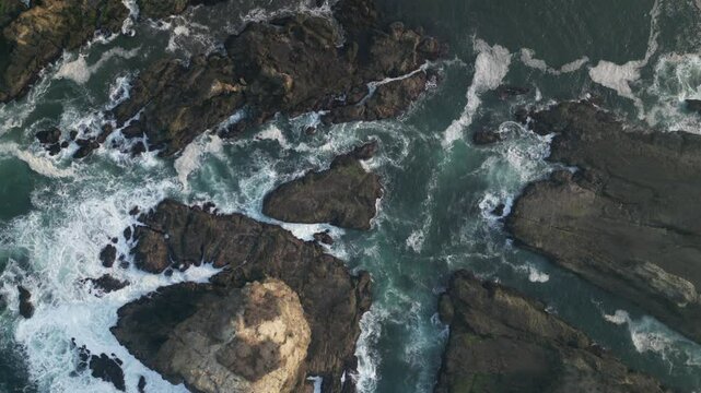 Aerial view of Papuma Beach Jember East Java with rocky beach and fishing boat on waves
