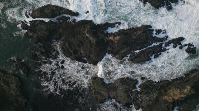 Aerial view of Papuma Beach Jember East Java with rocky beach and fishing boat on waves
