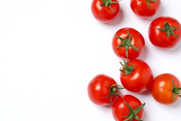 Flat lay composition with fresh cherry tomatoes and basil on white background. Ripe vegetables
