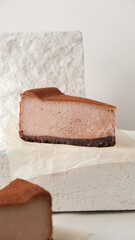 Close-up of a fork breaking a chocolate cake. chocolate cheesecake on a light background