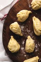 Culurgiones, typical ravioli of Sardinia. A first course of Sardinia: culurgiones or culugiornis, typical stuffed ravioli closed in an ear of wheat, best Sardinian culinary tradition, authentic taste 