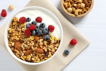 Delicious granola with berries and yogurt on the table