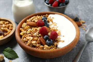 Delicious granola with berries and yogurt on the table