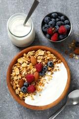 Delicious granola with berries and yogurt on the table