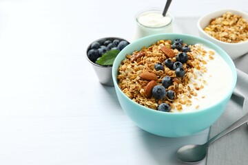 Delicious granola with berries and yogurt on the table
