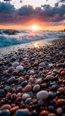 Obraz premium Scenic sunset over the ocean with colorful pebbles on the shore and gentle waves copy space 