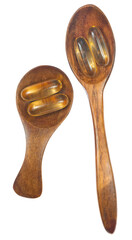 omega 3 pills in wooden spoon isolated on white background.