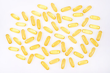 Omega 3 tablets isolated on white background . yellow pills close up. Fish oil capsules. Golden vitamin D3