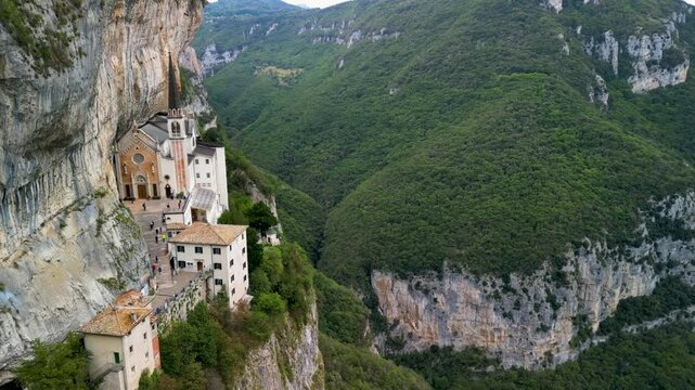 Panoramic aerial view of the Sanctuary of the Madonna della Corona, the church of Spiazzi, Caprino Veronese on the Monte Baldo massif, high above the Adige Valley, Italy