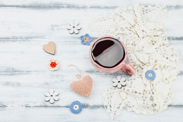 A cup of fragrant hibiscus tea and cute handmade decor. Good mood concept, cozy home comfort