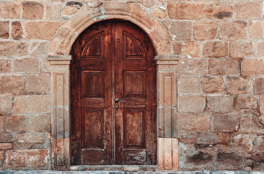 Old door on stone wall building