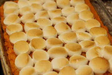 Sweet potato casserole topped with toasted marshmallows, a classic dessert.