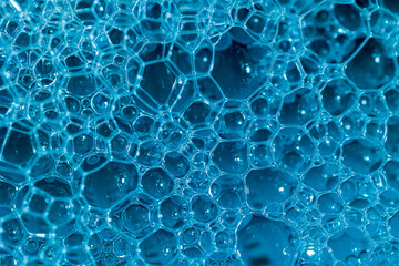 Intricate network of blue bubbles, a mesmerizing close-up of foamy texture. Ideal for backgrounds or abstract designs.