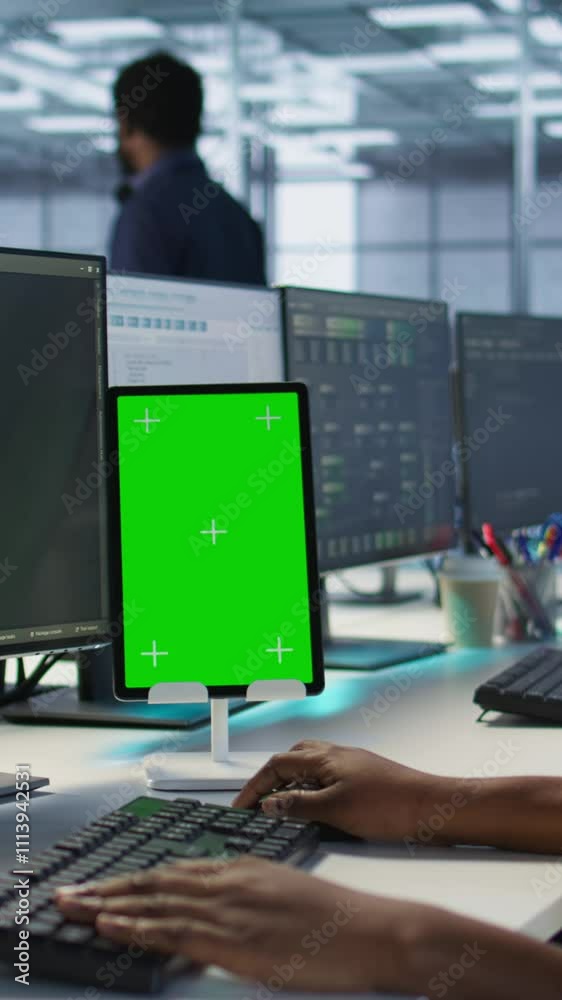 Poster vertical video programmers use isolated screen tablet in server room, developing disaster recovery p
