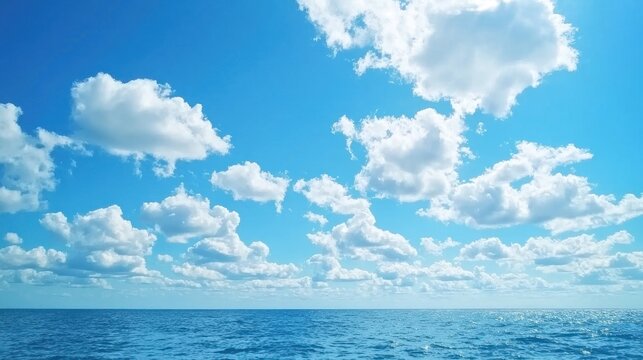 A wide open sky filled with thick, rolling clouds, creating a moody and dramatic scene over the ocean