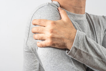 Arthritis symptoms, suffering from pain. The hands of the senior man massage a painful elbow. Inflamed male joint, stiffness of movement. Old age, health. Close up view..