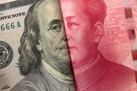 America dollar and Yuan banknote with USA and China flags. Its is symbol for tariff trade war crisis between biggest economic country in the world.