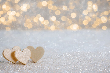 Fototapeta premium A close up of four gold hearts on a white background