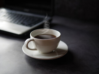 Relax during business work concept, americano coffee cup and black coffee cup aromatic and laptop computer in morning